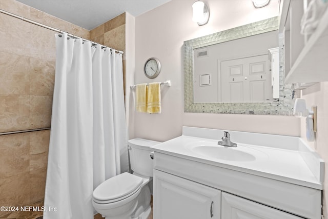 bathroom featuring vanity, curtained shower, and toilet