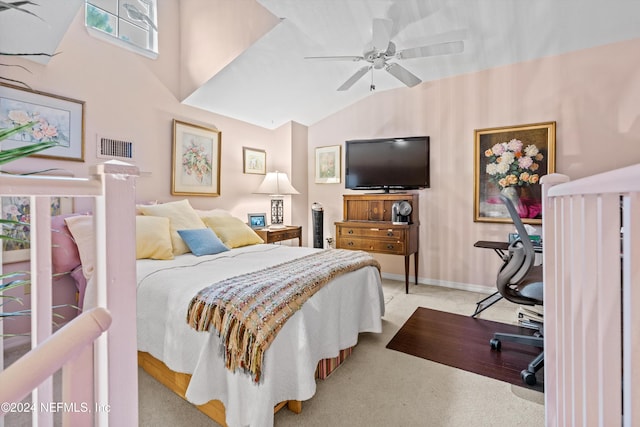 carpeted bedroom featuring ceiling fan and vaulted ceiling