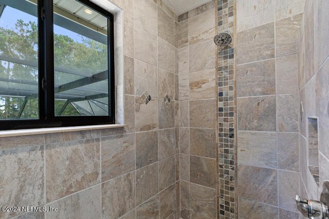 bathroom with tiled shower