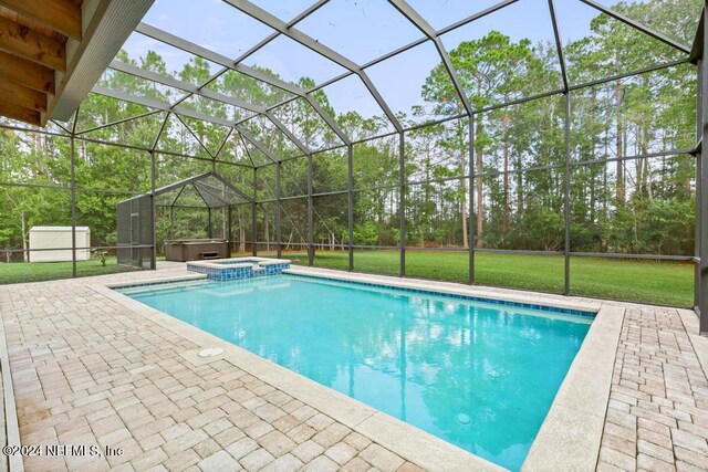 view of swimming pool with a patio, a lanai, and an in ground hot tub