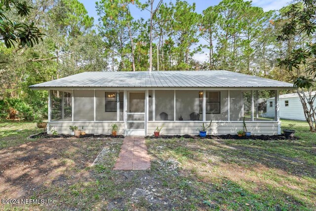 view of front of property featuring a sunroom