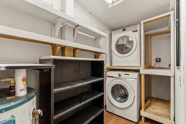 laundry room with light hardwood / wood-style flooring and stacked washer and clothes dryer