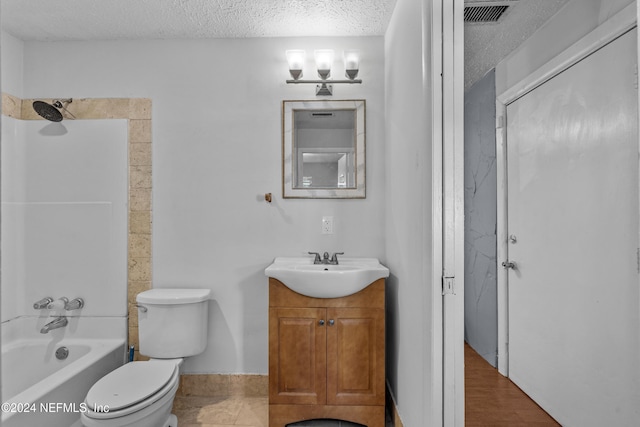 full bathroom featuring wood-type flooring, a textured ceiling, toilet, vanity, and bathtub / shower combination