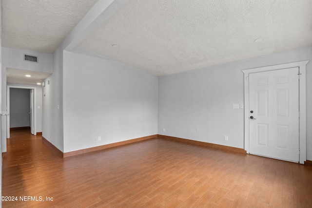 interior space featuring hardwood / wood-style flooring and a textured ceiling