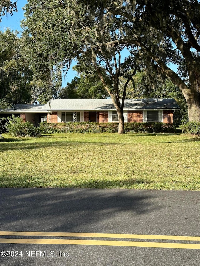 ranch-style house with a front lawn