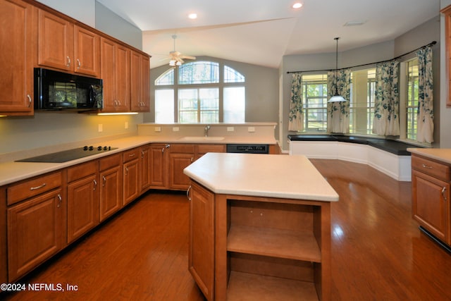 kitchen with lofted ceiling, black appliances, decorative light fixtures, a kitchen island, and dark hardwood / wood-style flooring