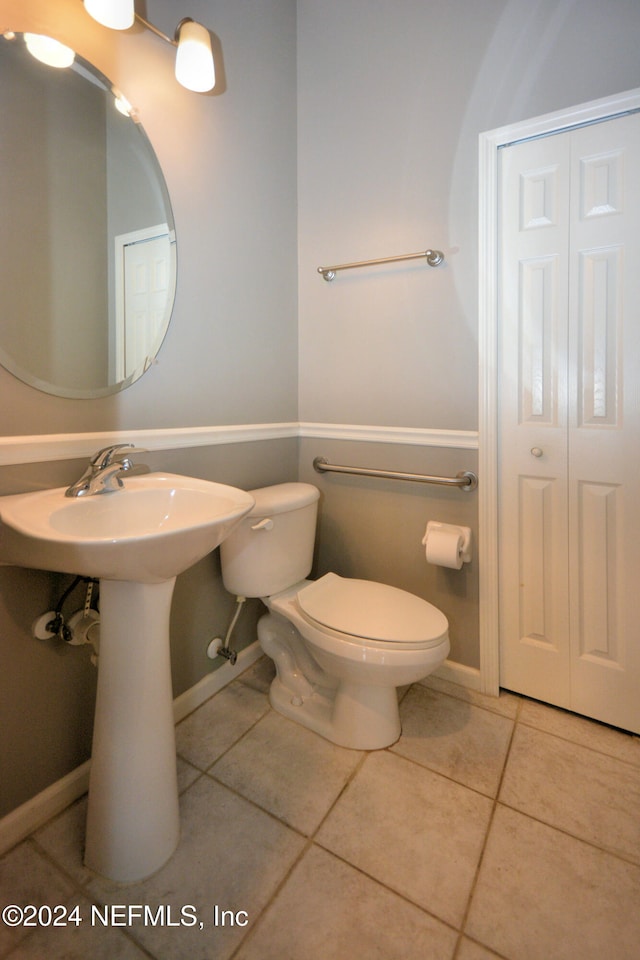 bathroom featuring tile patterned flooring and toilet