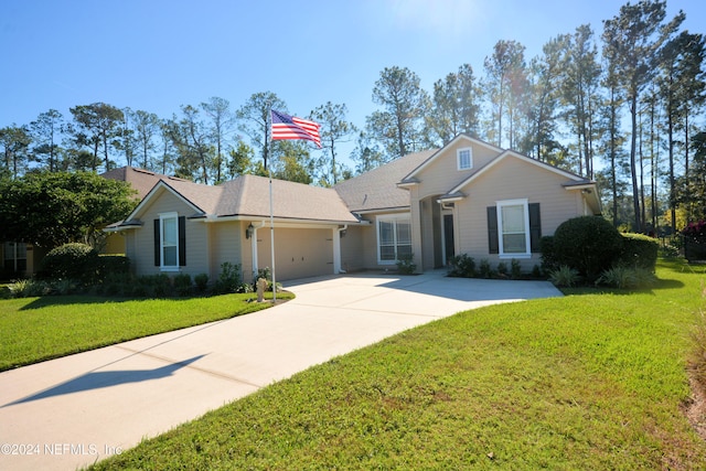 single story home with a garage and a front lawn