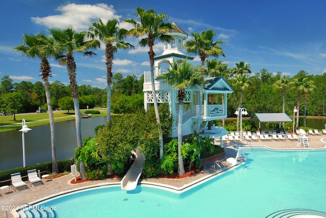 view of swimming pool with a water view and a patio