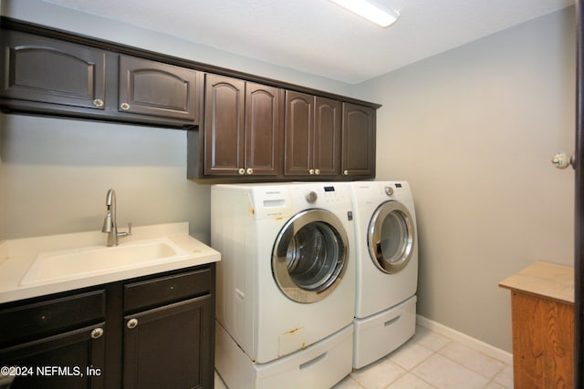 washroom featuring cabinets, washing machine and clothes dryer, and sink