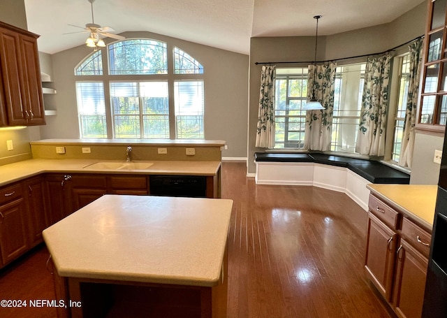 kitchen with black dishwasher, dark hardwood / wood-style floors, a kitchen island, and sink