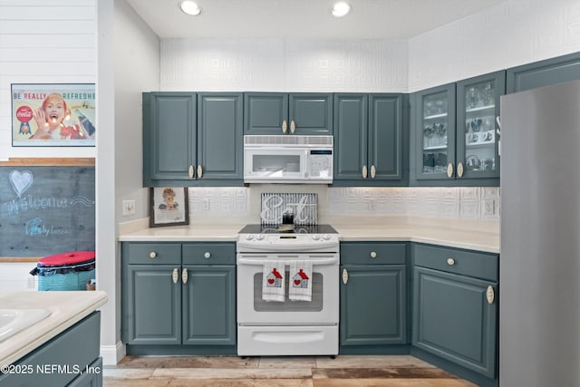 kitchen with light wood-type flooring and white appliances