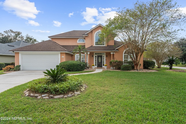 view of front of property featuring a garage and a front lawn