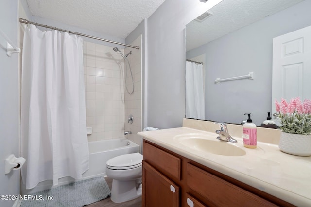 full bathroom featuring a textured ceiling, shower / tub combo with curtain, vanity, wood-type flooring, and toilet