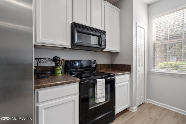 kitchen with black appliances, light hardwood / wood-style flooring, and white cabinets