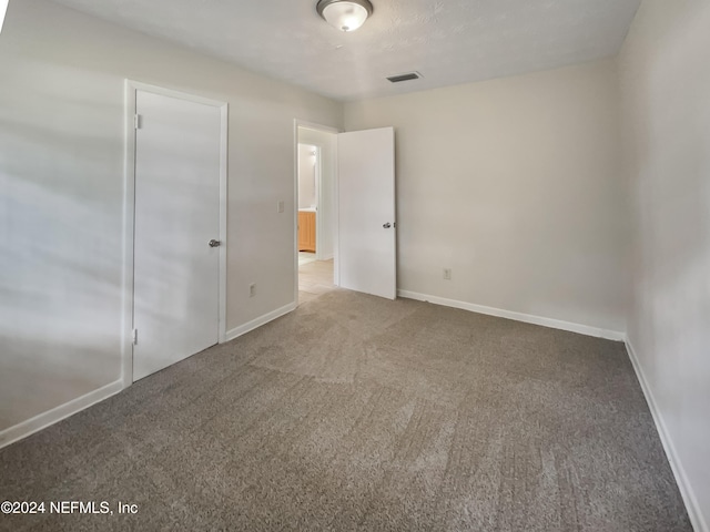 unfurnished bedroom featuring a closet and carpet floors