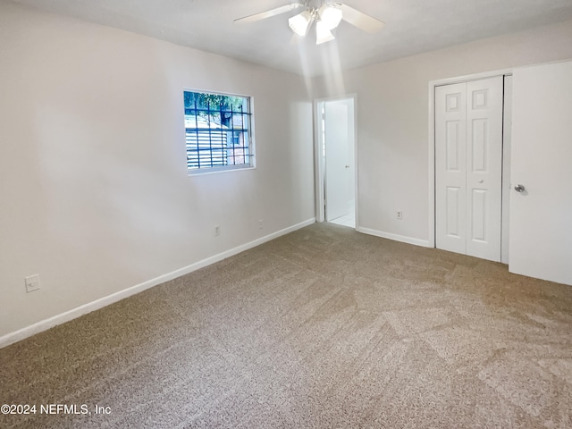 empty room with carpet flooring and ceiling fan