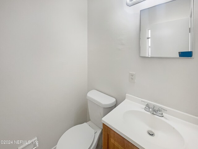 bathroom with toilet and vanity