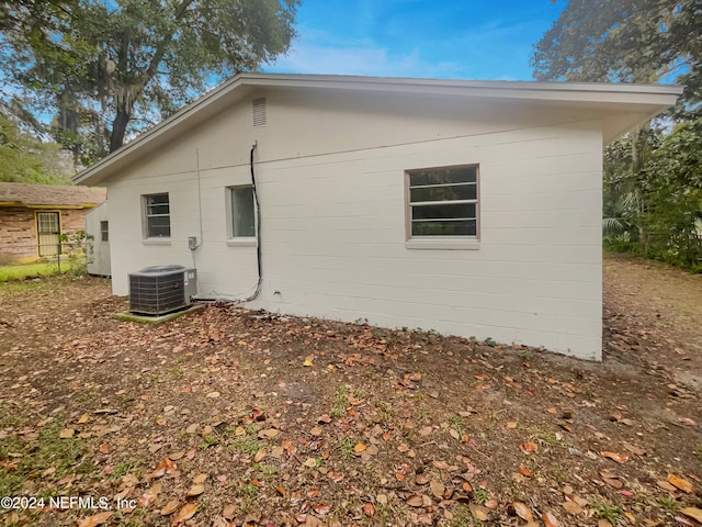 view of side of home with central AC