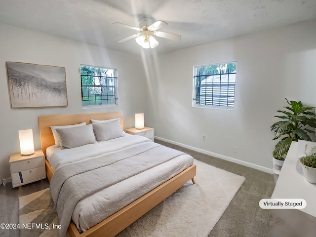 bedroom featuring multiple windows and ceiling fan