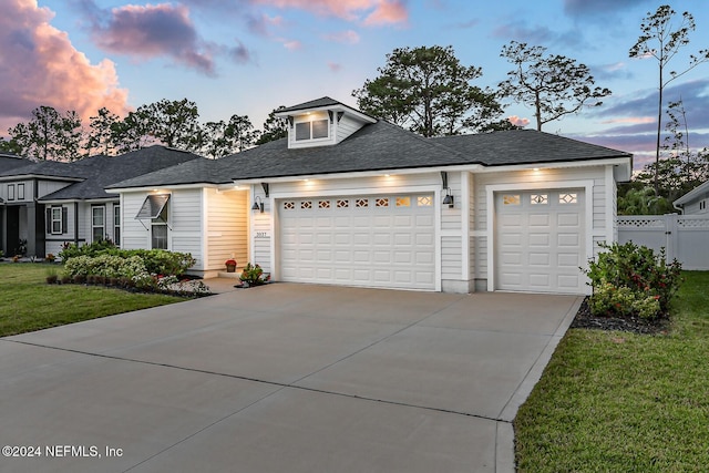 view of front facade with a garage and a yard