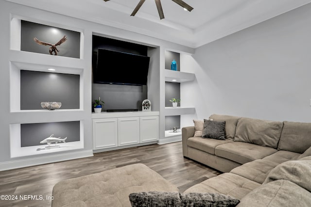 living room featuring built in features, ceiling fan, and light hardwood / wood-style floors