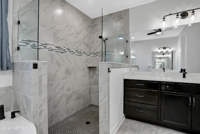 bathroom featuring vanity, ceiling fan, and a tile shower