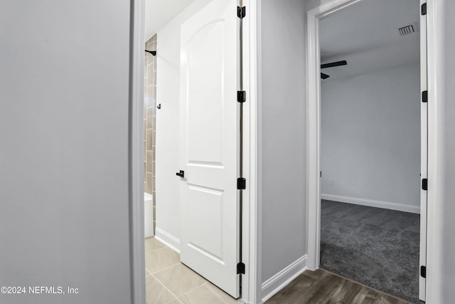 corridor with hardwood / wood-style flooring