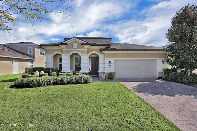 view of front of house with a front yard and a garage