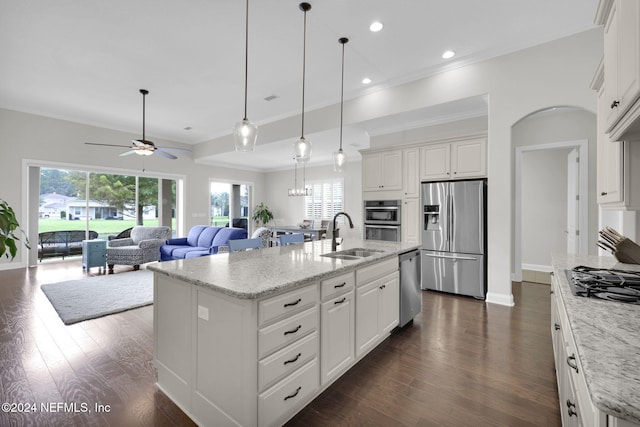 kitchen featuring stainless steel appliances, sink, white cabinets, dark wood-type flooring, and a kitchen island with sink