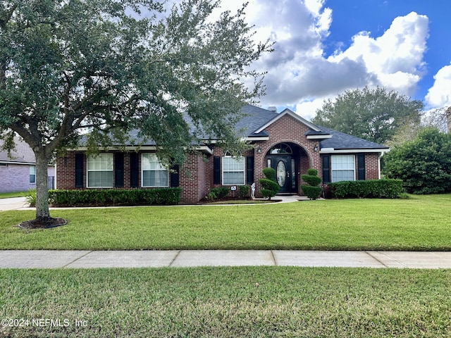 ranch-style home featuring a front yard