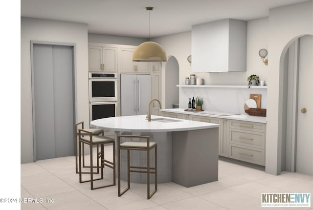 kitchen with pendant lighting, a breakfast bar, light tile patterned flooring, sink, and appliances with stainless steel finishes