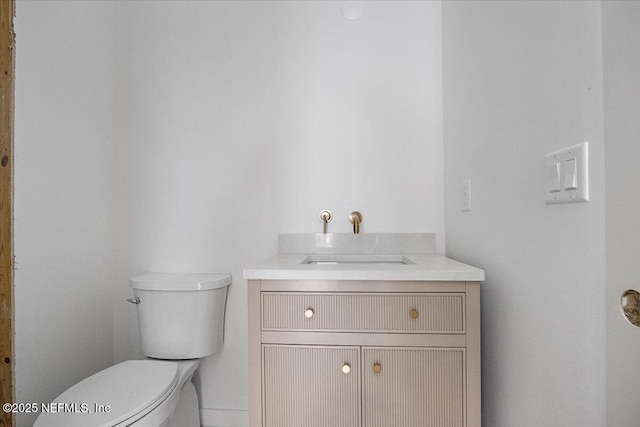 bathroom with toilet and vanity