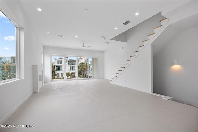 unfurnished living room featuring ceiling fan