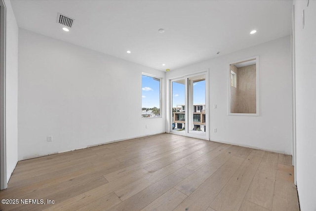 spare room featuring light hardwood / wood-style floors