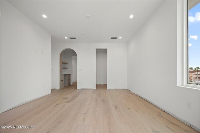 unfurnished room with light wood-type flooring