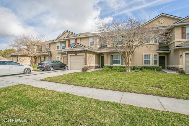 multi unit property with a garage and a front yard