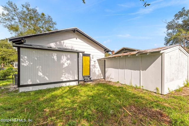 rear view of property featuring a yard