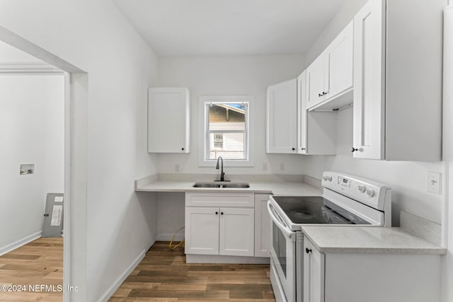 kitchen with dark wood-type flooring, electric stove, sink, and white cabinets