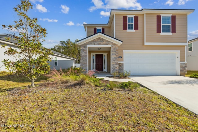 view of front of property featuring a garage, driveway, and stone siding