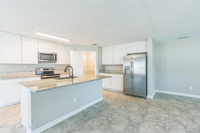 kitchen featuring white cabinets, appliances with stainless steel finishes, and sink