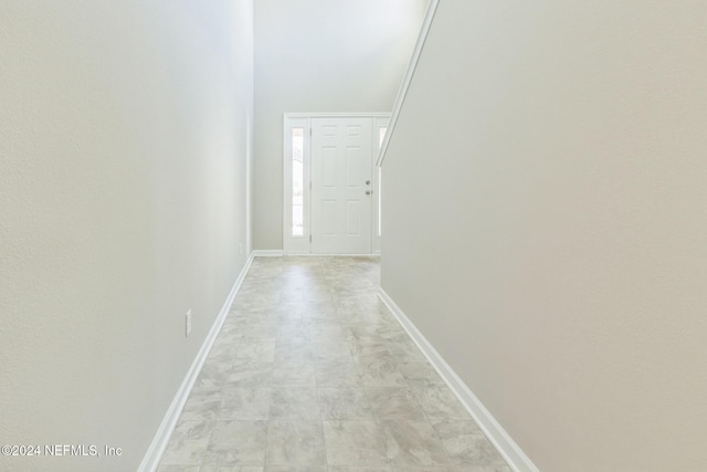 corridor featuring vaulted ceiling