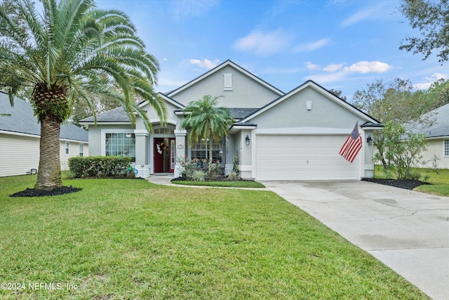 549 N Bridgestone Ave, Saint Johns, FL 32259 - ranch-style home featuring stucco siding, an attached garage, driveway, and a front lawn