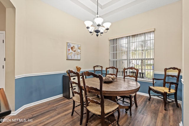 dining room featuring dark hardwood / wood-style flooring and an inviting chandelier