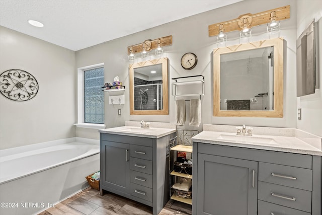 bathroom featuring vanity, hardwood / wood-style floors, and separate shower and tub