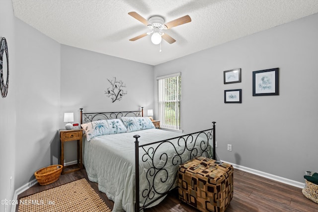 bedroom featuring dark wood-type flooring, ceiling fan, and a textured ceiling