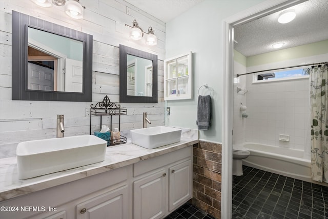 full bathroom featuring toilet, tile patterned flooring, a textured ceiling, vanity, and shower / tub combo