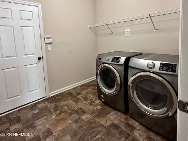 clothes washing area with washer and clothes dryer