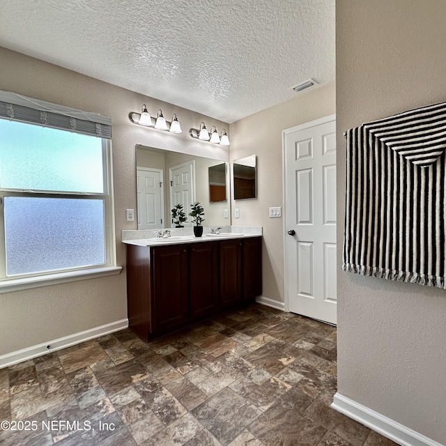 bathroom with vanity and a textured ceiling