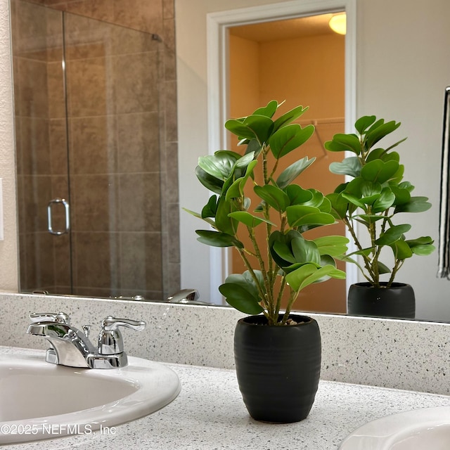 bathroom with vanity and a shower with door